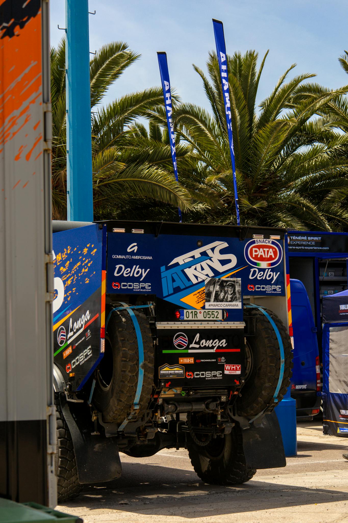 Rugged rally truck equipped for off-road challenges, parked outdoors.